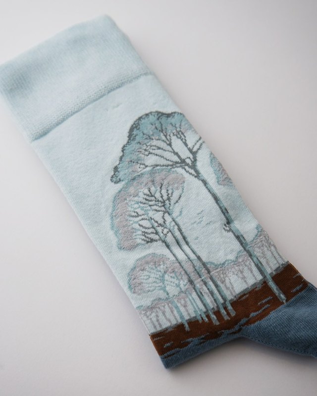 The trees around the leg, the field as a brown border.